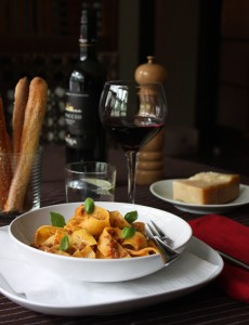 Cooked Pappardelle with an Authentic Bolognese Sauce and Fresh Basil Leaves