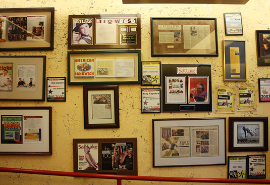 A very full "press wall" greets customers at Tony Caputo's, Salt Lake City.