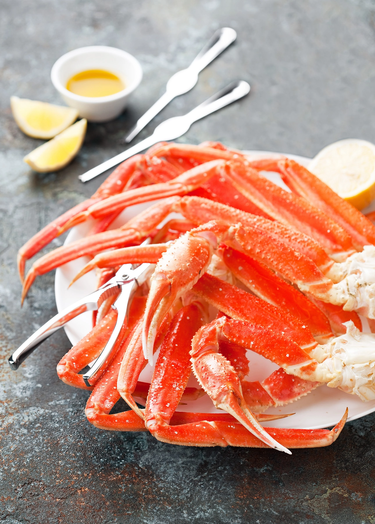 A plate of snow crab legs with lemon // FoodNouveau.com