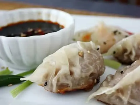 Beef dumpling wrapped with classic pleated crescent method.