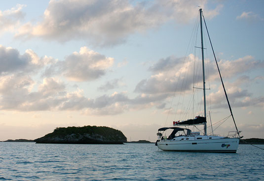Our sailboat, the Congo, as the sun sets on Warderick Wells Cay.
