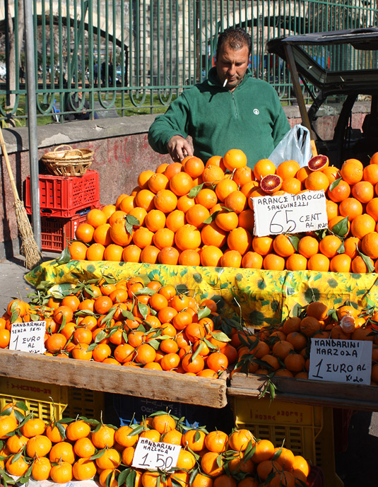 An man selling oranges along Catania's fortifications - he was literally unloading the oranges off his trunk