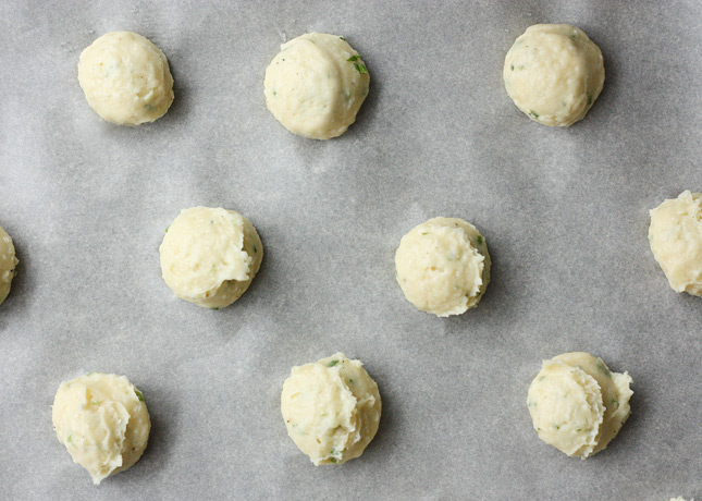 How to Make Gougères: Using Damp Fingertips to Press Down Peaks of Dough // FoodNouveau.com