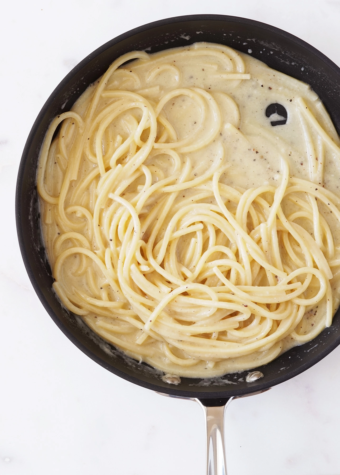 A skillet with freshly made Cacio e Pepe, a classic pasta recipe from Rome, Italy // FoodNouveau.com