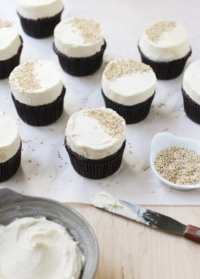 Cupcake fatigue? This recipe is your remedy. The tahini buttercream is slightly nutty and perfectly fluffy: a perfect match to the dark chocolate cupcakes! // Dark Chocolate Cupcakes with Tahini Buttercream // FoodNouveau.com