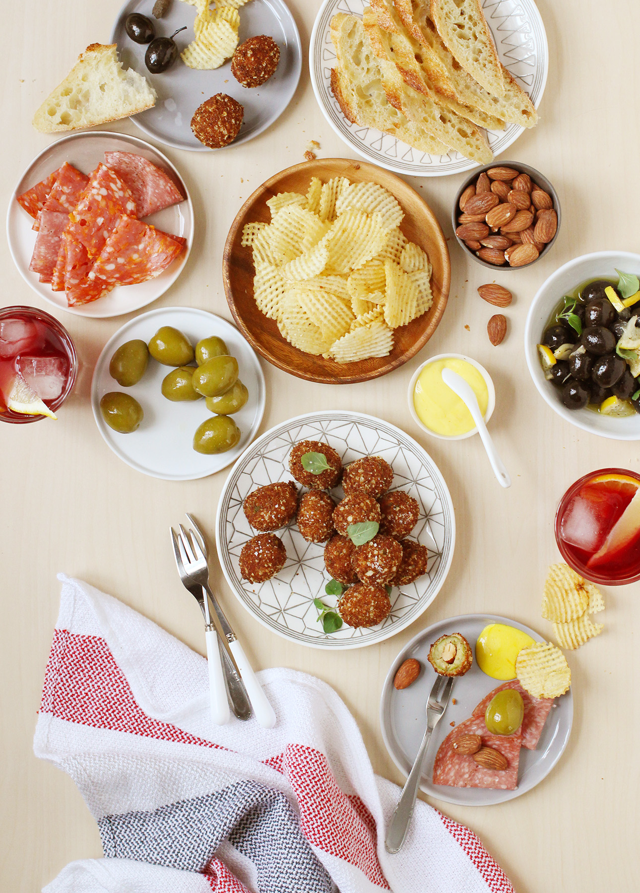 A selection of delicious snacks for happy hour, including fried olives with saffron aïoli // FoodNouveau.com