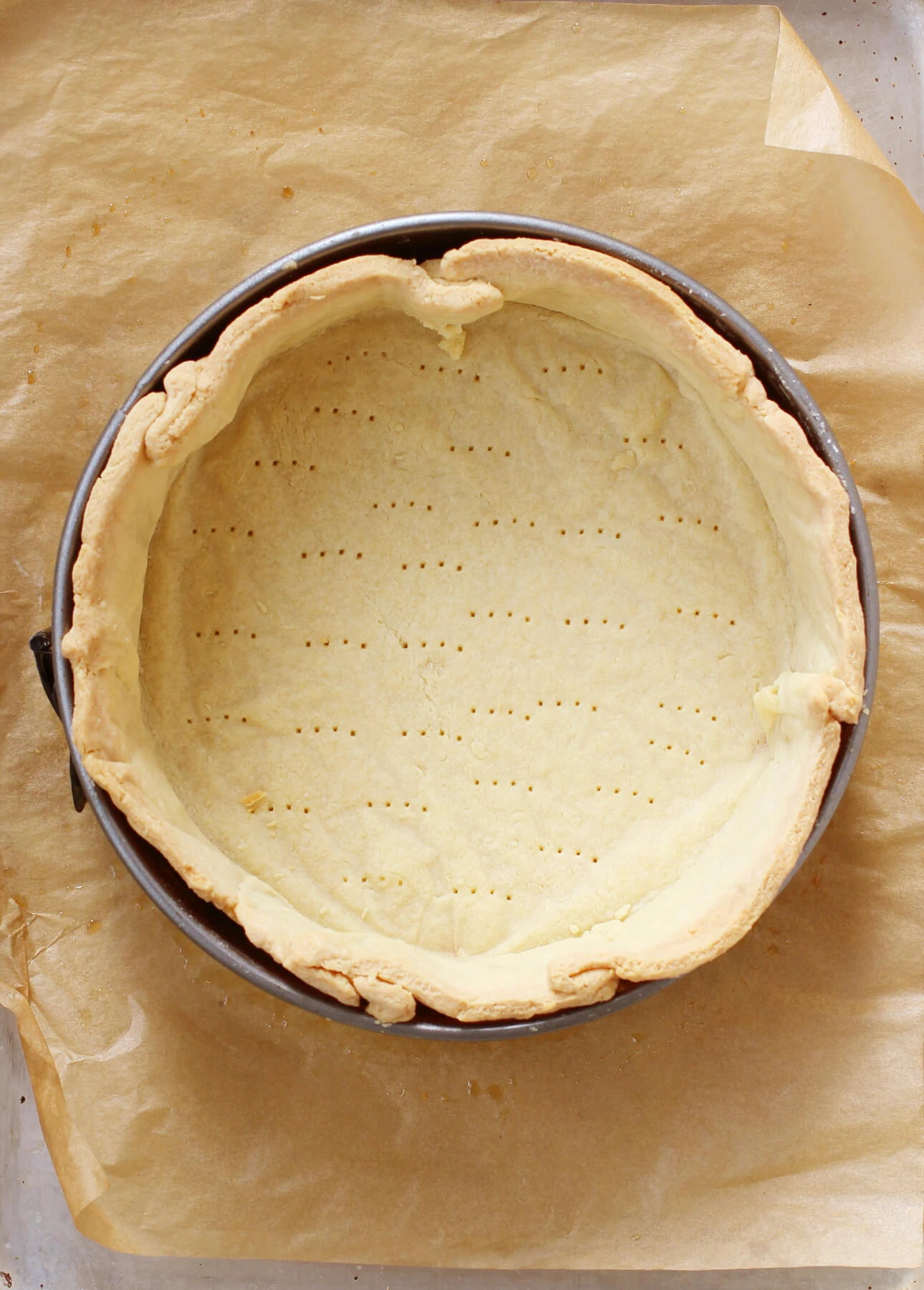 An empty, blind baked tart shell that will be used to make classic quiche lorraine // FoodNouveau.com