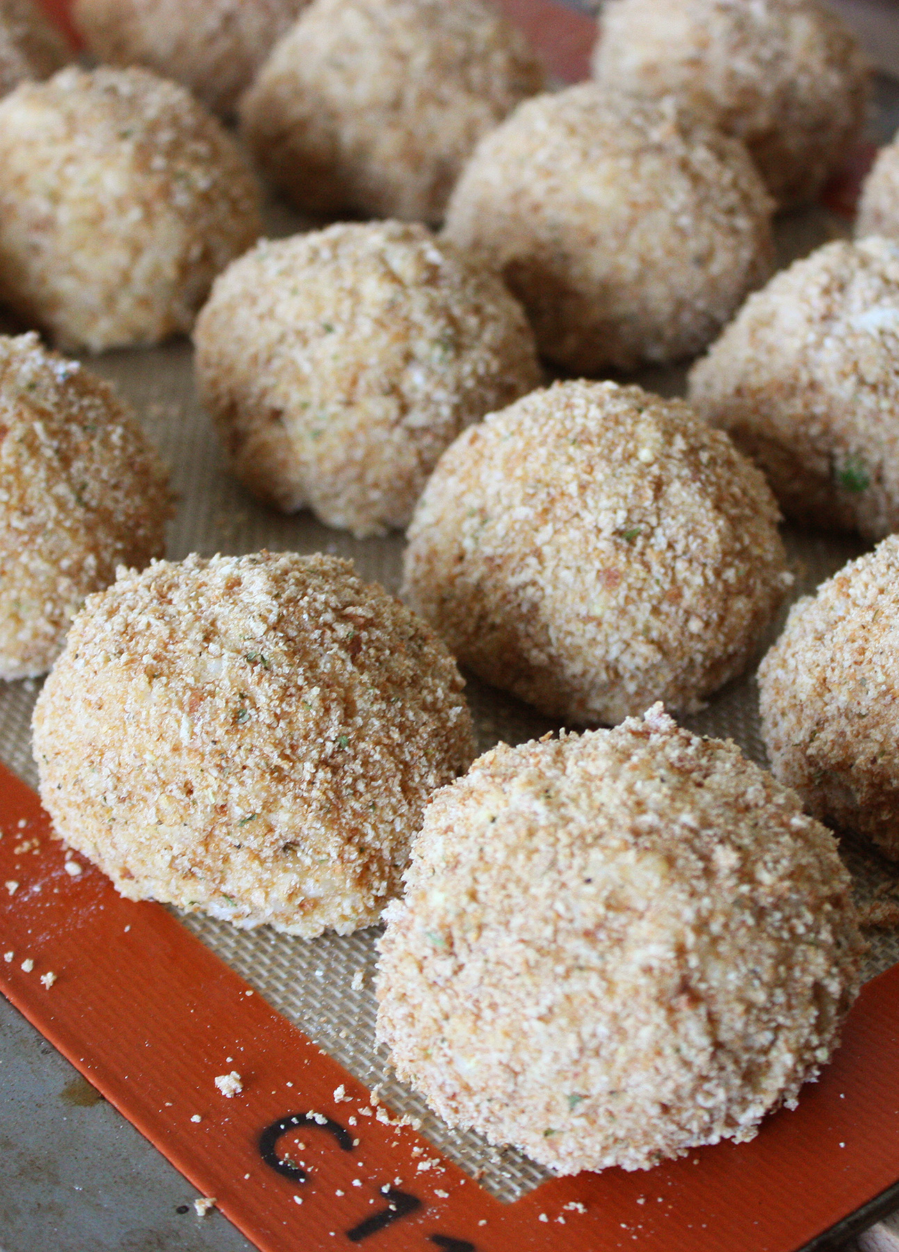 Shaped arancini (Sicilian risotto balls), ready to be deep-fried // FoodNouveau.com