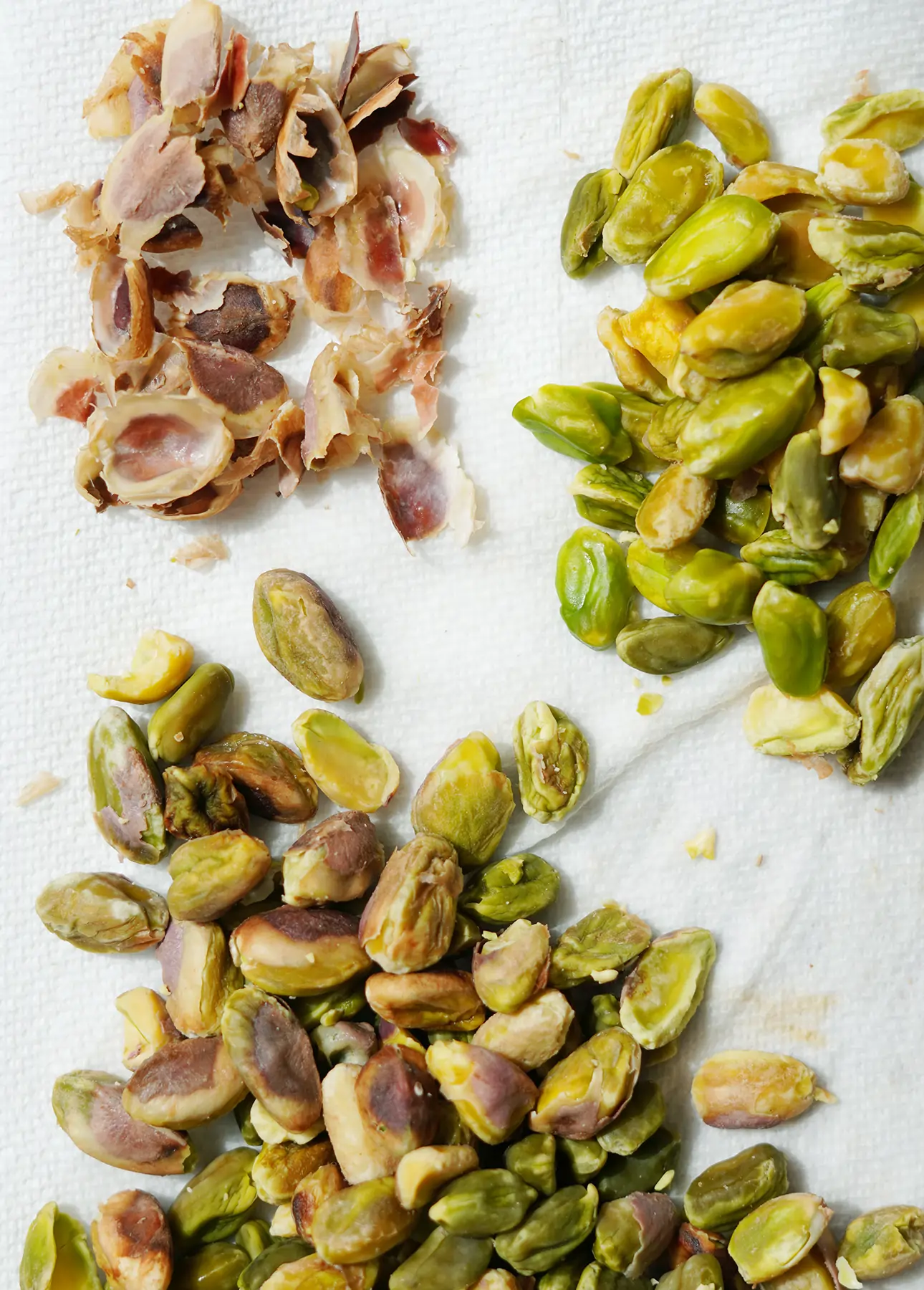 Peeling blanched pistachios to create a smoother, creamier pistachio semifreddo // FoodNouveau.com