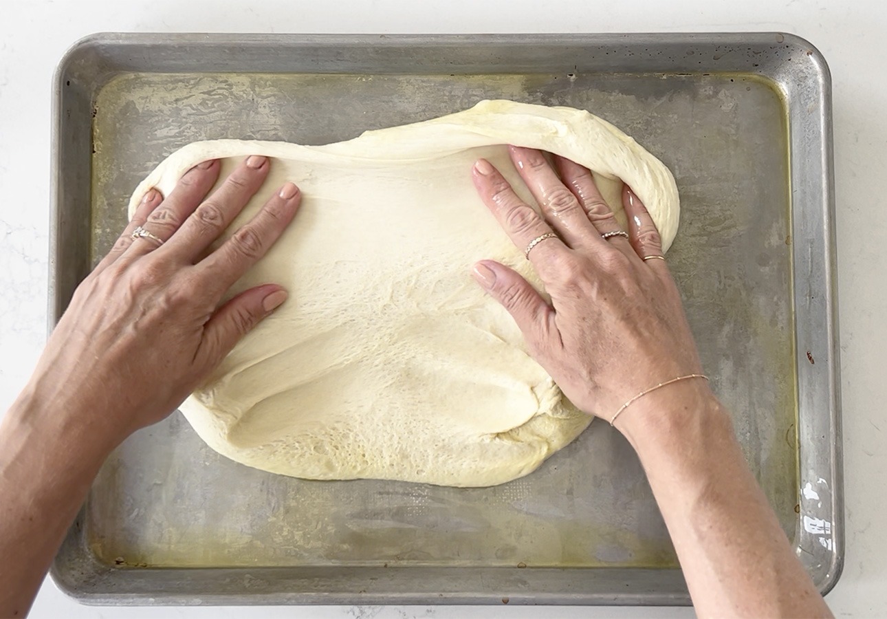 Spreading dough to make pissaladière, a French flatbread // FoodNouveau.com